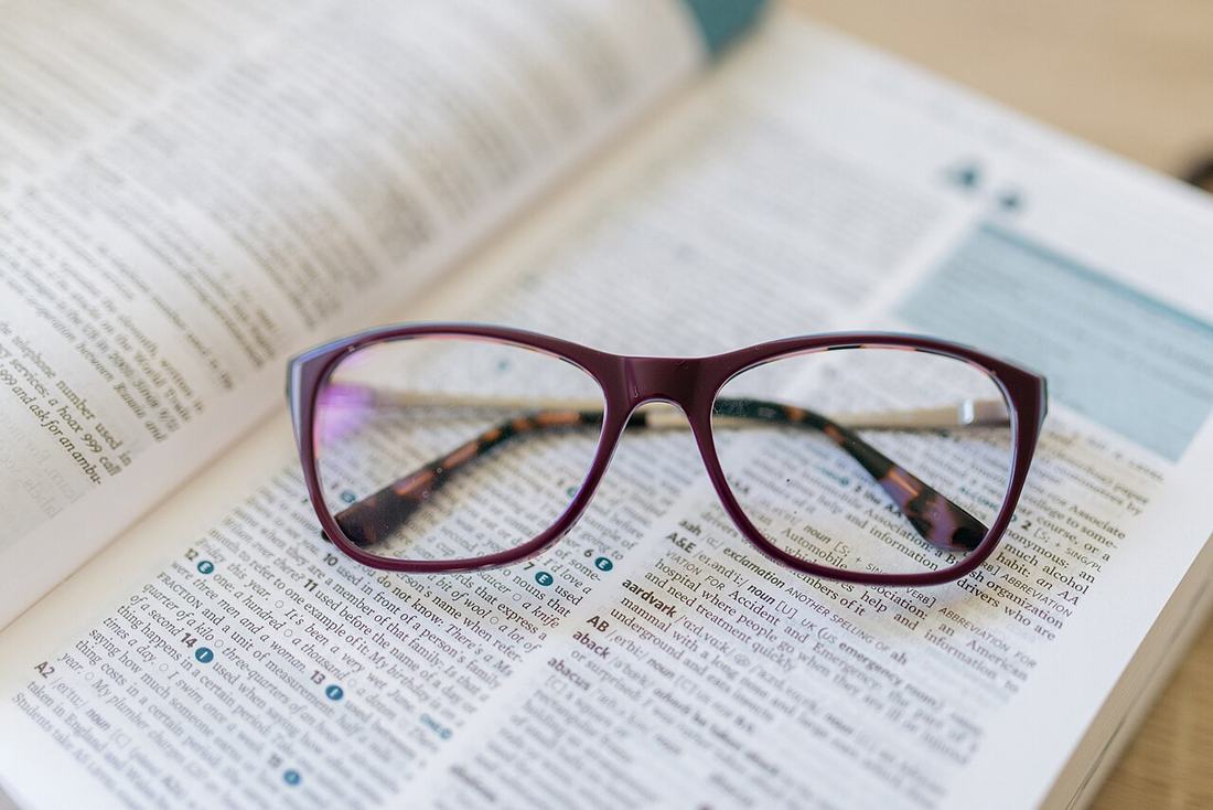 Reading glasses on an open book