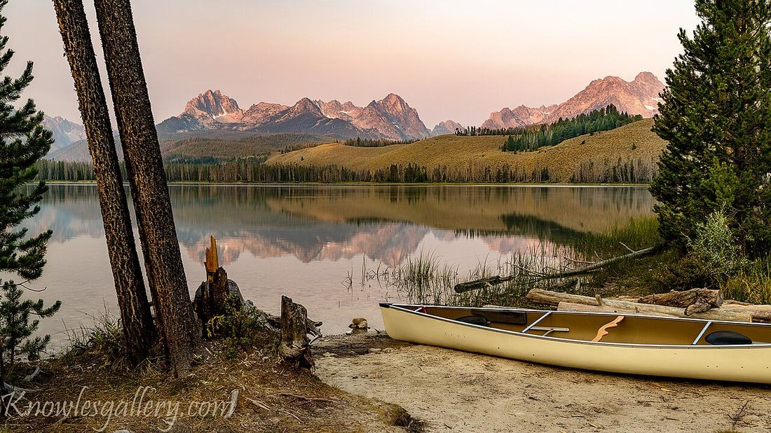 A canoe on the shore at sunrise